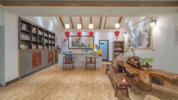 A reception area with a counter, seating, and a bookshelf.
