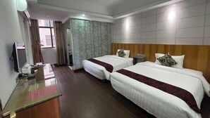 A hotel room with two beds, a desk, a chair, a TV, and a window with curtains. - Starry Inn (Renhua)