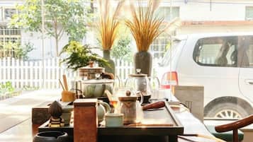 A table with various items including a vase, a teapot, and a small figurine.