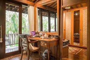 A wooden desk with a chair, a window with curtains, and a wardrobe with a mirror. - The Lavana Ziza Living And Villas Seminyak (Bali)