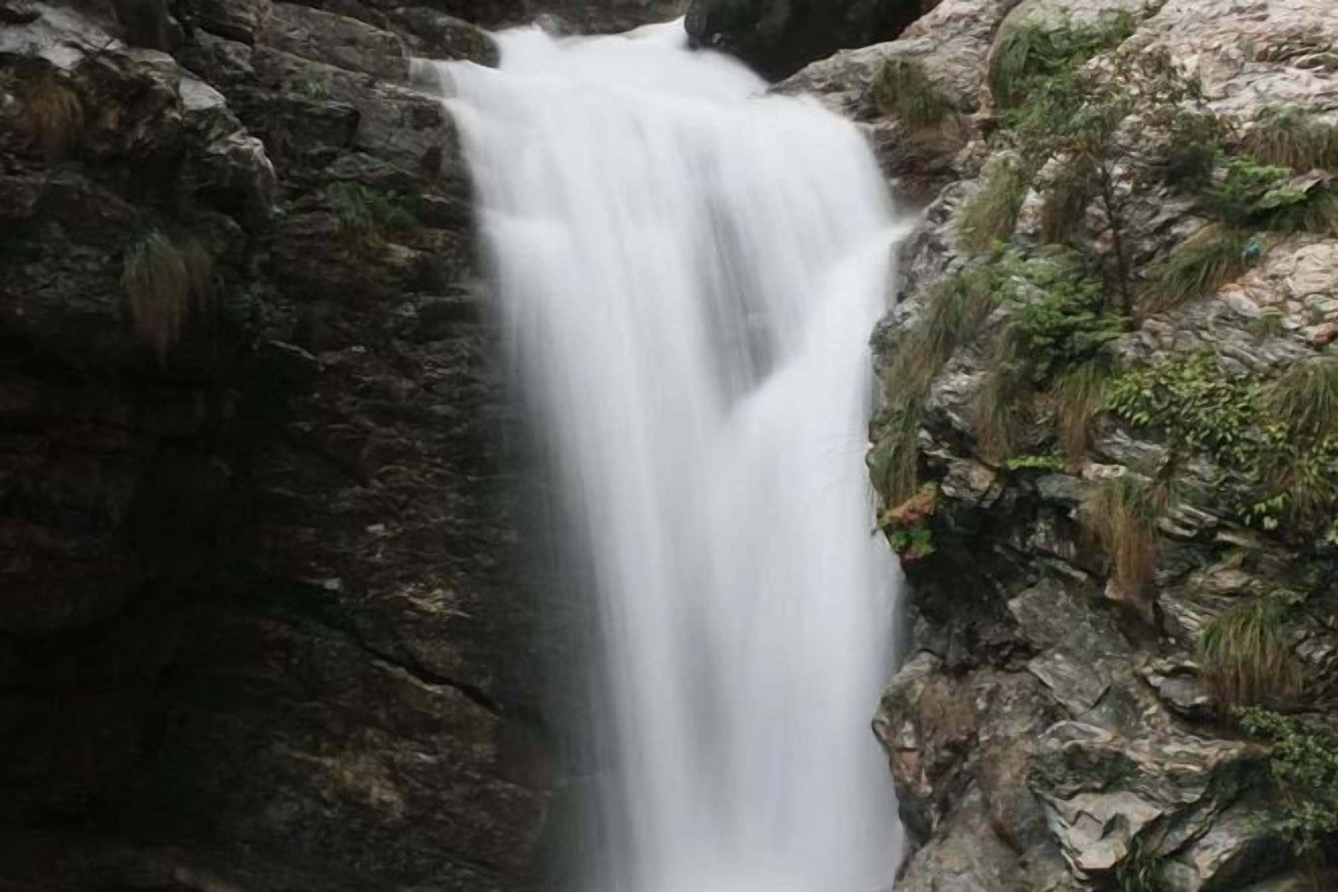 A waterfall cascading down a rocky cliff.