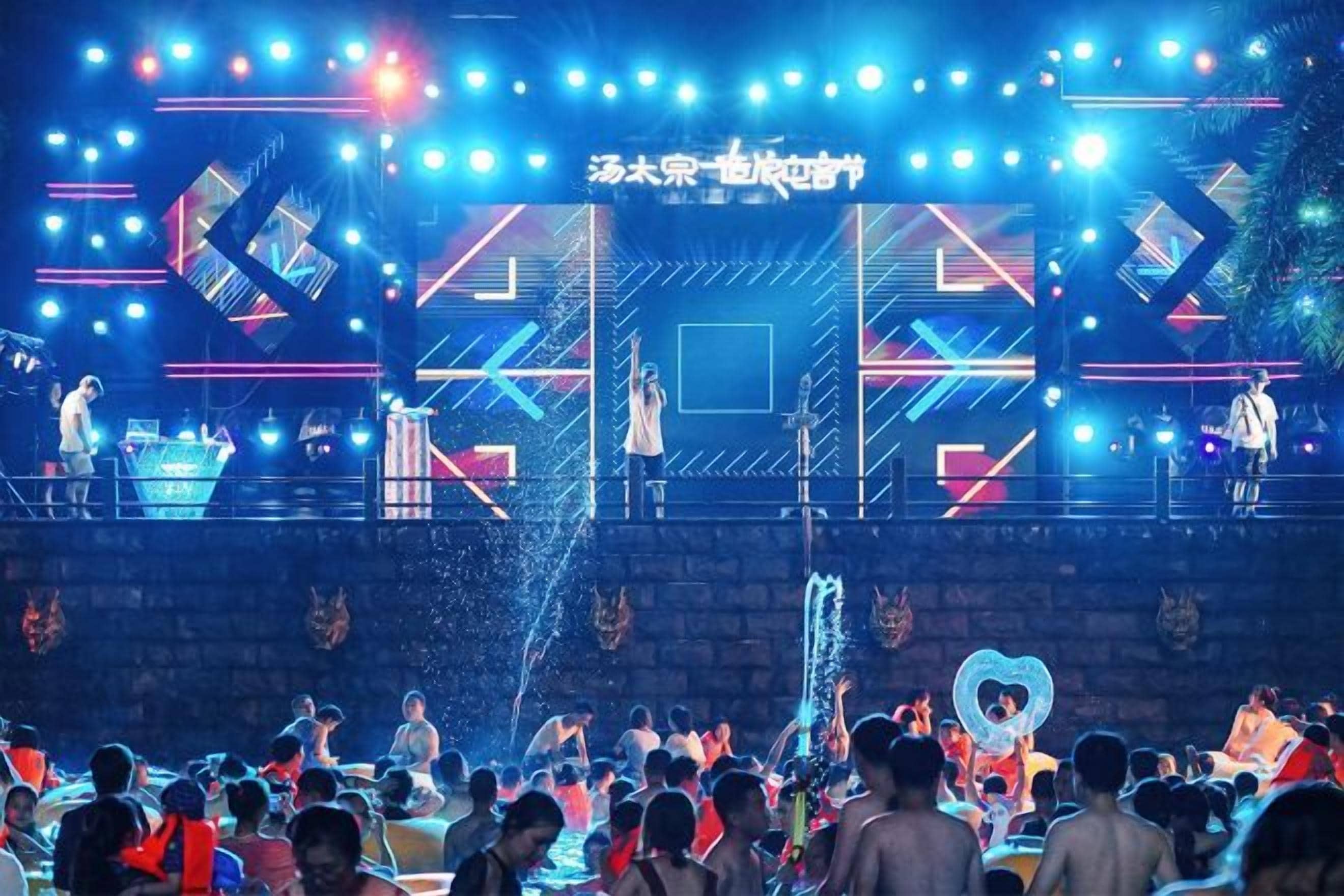 A stage with a geometric design and a crowd of people.
