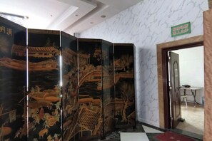 A room with a traditional Japanese sliding door, a small table, and a sign indicating a private area. - Haopai Hotel (Shantou)