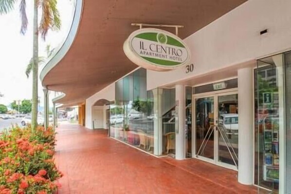 The exterior of IL Centro Apartment Hotel with a covered entrance, glass doors, and a visible number 30.