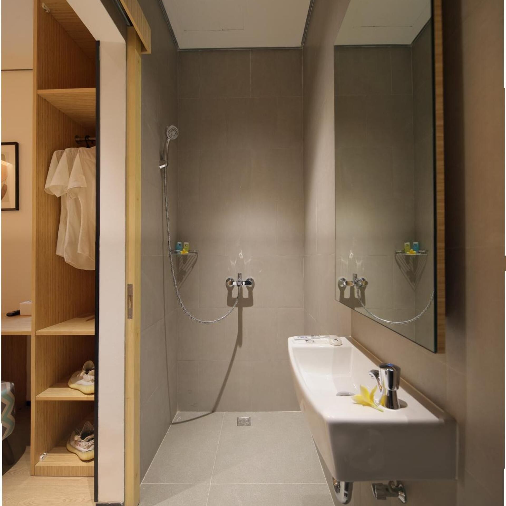 A modern bathroom with a shower, a sink, and a mirror.