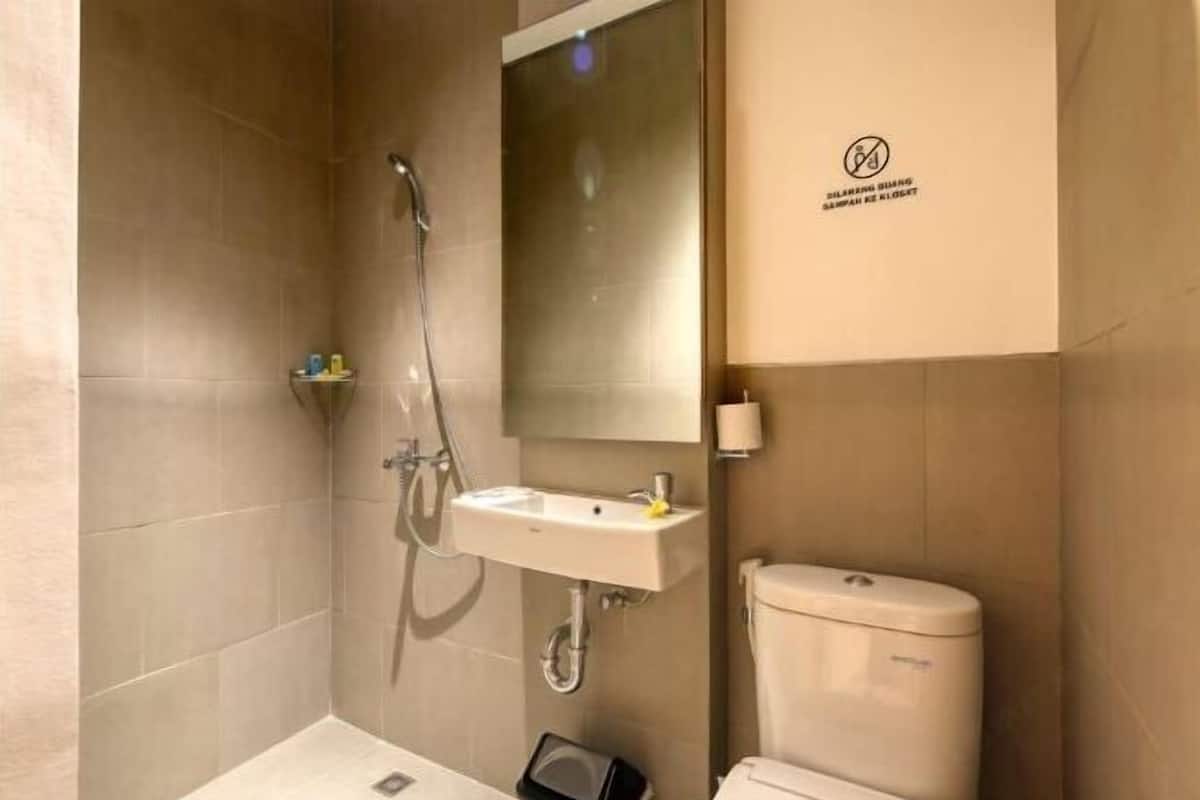 A bathroom with a shower, sink, and toilet.