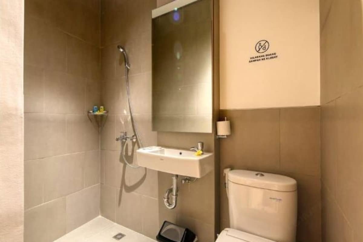 Une salle de bain avec une douche, un lavabo et des toilettes.