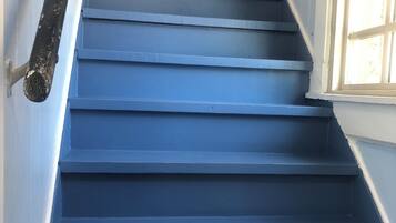 A set of blue stairs leading to a landing.