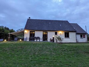 A two-story house with a covered patio and a lawn in front. - Peaceful House With SPA (Ablon)