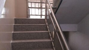 A staircase with metal railings leading to an upper floor.