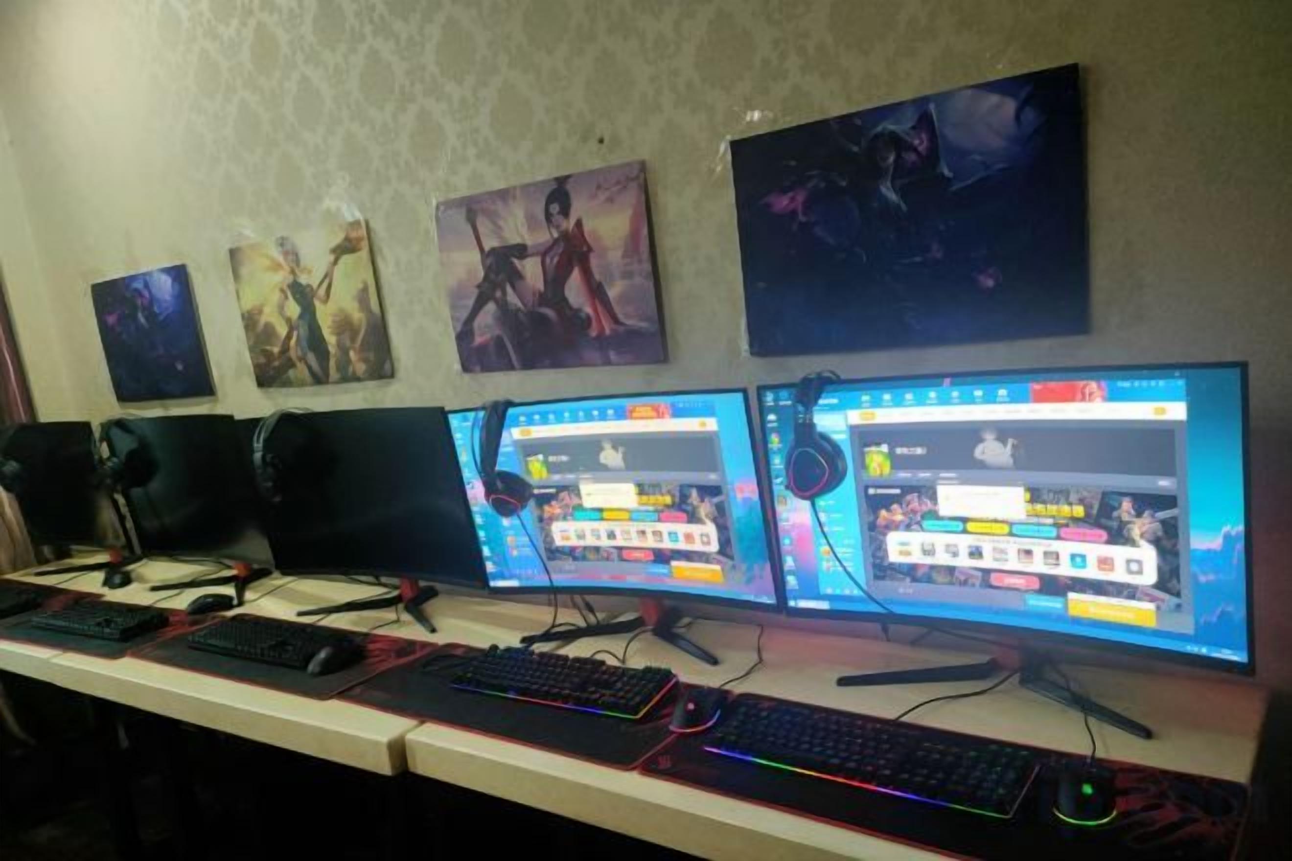 A gaming setup with multiple monitors, keyboards, and headphones.