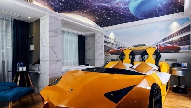 A room with a unique ceiling design, a modern car, and a window with curtains. - WP Guo Creative Hotel (Cangnan EMU Station Store) (Cangnan)