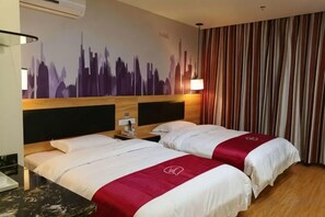 A hotel room with two beds, a cityscape mural, a striped curtain, and a wooden headboard. - Pu'er Shihoude Inn (Pu'er)