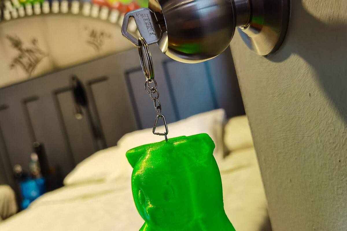 A green keychain hanging from a door handle.