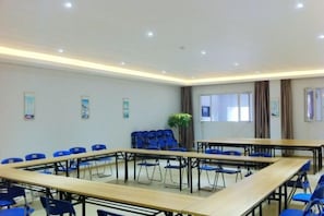 A conference room with a large table, blue chairs, and a potted plant. - SWT(sweetheart) Express Hotel (Dongguan)