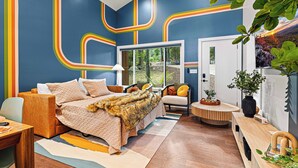 A modern bedroom with a large bed, a desk, a chair, and a small table with a plant. - Lamplighter House - Hot Tub, Firepit, Sauna & Games 15-min from Asheville, NC (Candler)