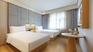 A hotel room with two beds, a small round table, a TV, and a large window with curtains. - JI Hotel (Beijing South Railway Station Jiaomen East Subway Station) (Beijing)