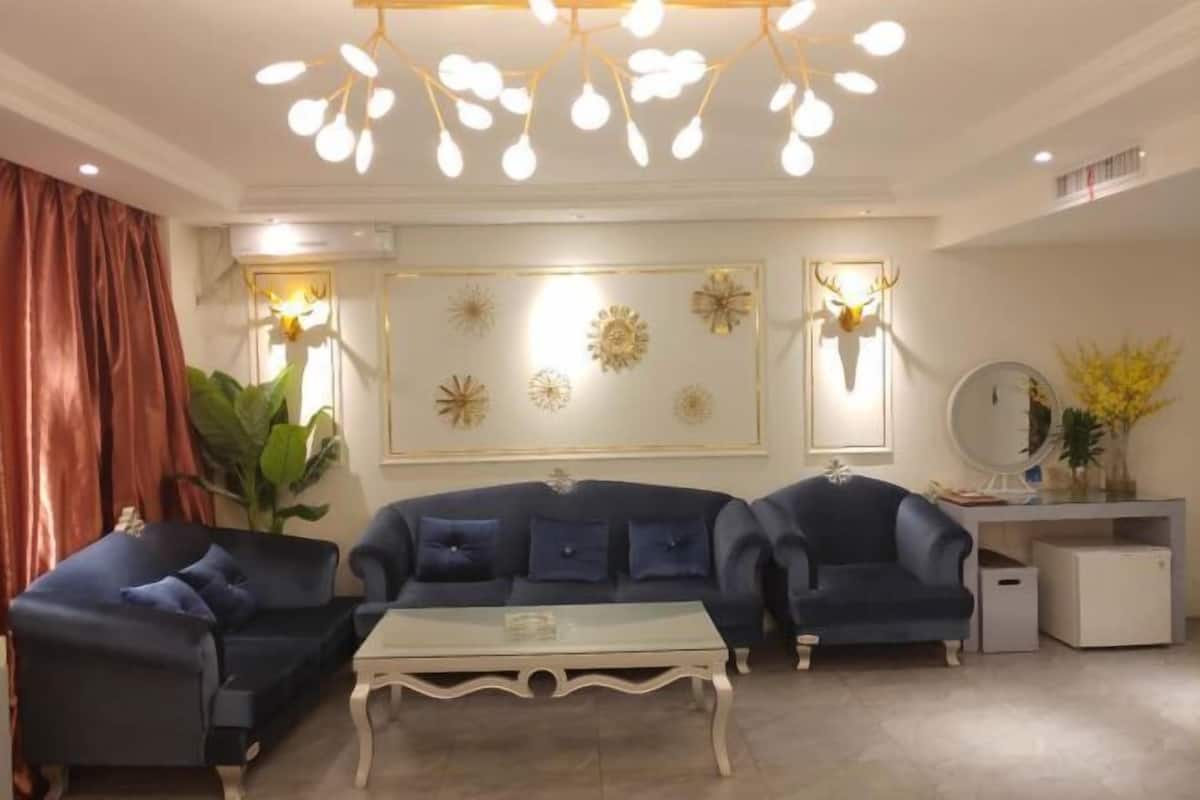 A living room with two sofas, a coffee table, and decorative wall art.