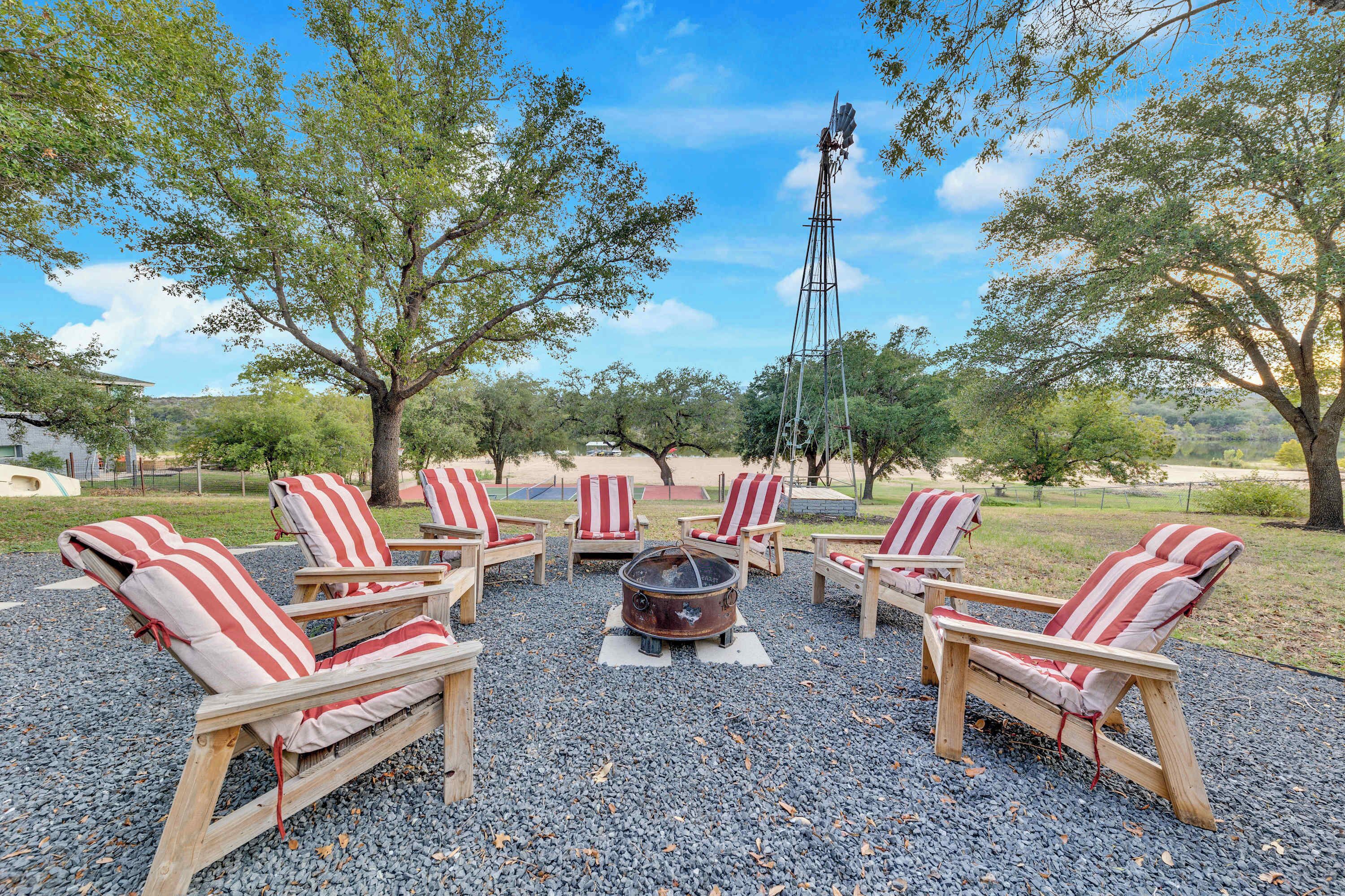 Swap stories and make smores together at the back yard firepit on the wooden chairs