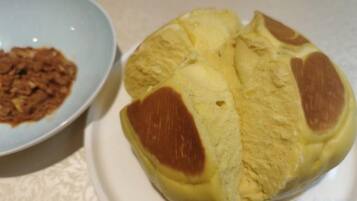 Une assiette avec un dessert jaune et un bol contenant un plat brun.