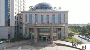 A modern building with a dome and columns, featuring signage in a foreign language. - Gulf Hotel (Longkou)