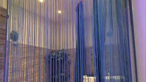 A room with a stone wall and a large window with vertical blinds. - Guoran Theme Hotel (Wuhan Huquan) (Wuhan)