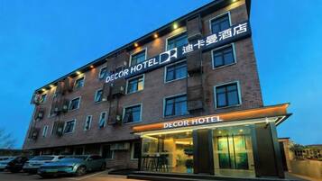 A multi-story hotel with a prominent entrance and signage.