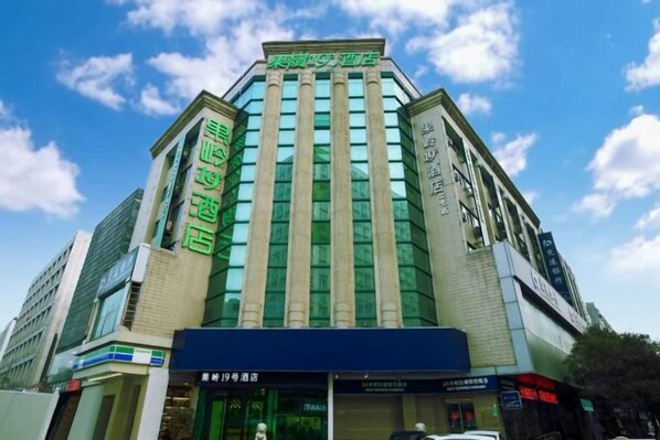 A modern hotel with a prominent entrance and signage indicating amenities such as a spa and restaurant.