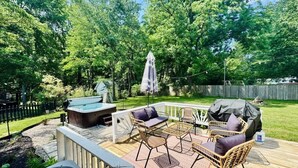 A deck with outdoor furniture, a hot tub, and a grill. - Hot Tub - Game Room - Sleeps 10 - Akron (Akron)