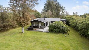 A modern house with a covered porch, a deck, and a small garden. - Pet friendly home in Spøttrup with WiFi (Spøttrup)