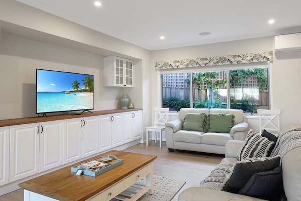 📺 Bright lower lounge featuring smart TV, air conditioning, and cozy seating