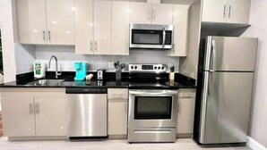 A modern kitchen with stainless steel appliances, including a dishwasher, oven, microwave, and refrigerator. - 406 The easy stays in central city of Philadelphia (Philadelphia)