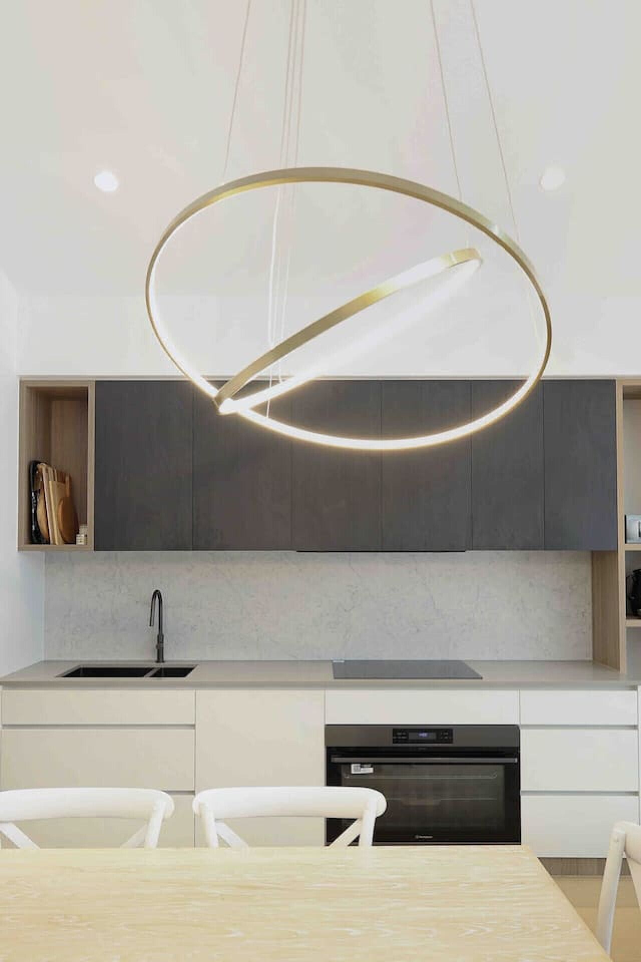 A modern kitchen with a central island, a built-in oven, and a pendant light fixture.