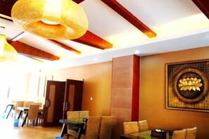 A hotel lobby with a high ceiling, a large woven light fixture, and a wall-mounted artwork. - Mengla Zai Ya Ge Ha Hotel (Mengla)