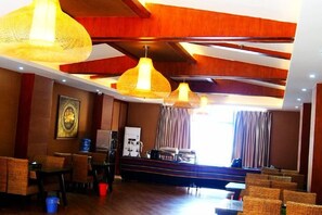 A hotel lobby with a wooden ceiling, wicker furniture, and pendant lighting. - Mengla Zai Ya Ge Ha Hotel (Mengla)