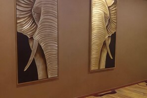A wall with two framed artwork pieces. - Mengla Zai Ya Ge Ha Hotel (Mengla)