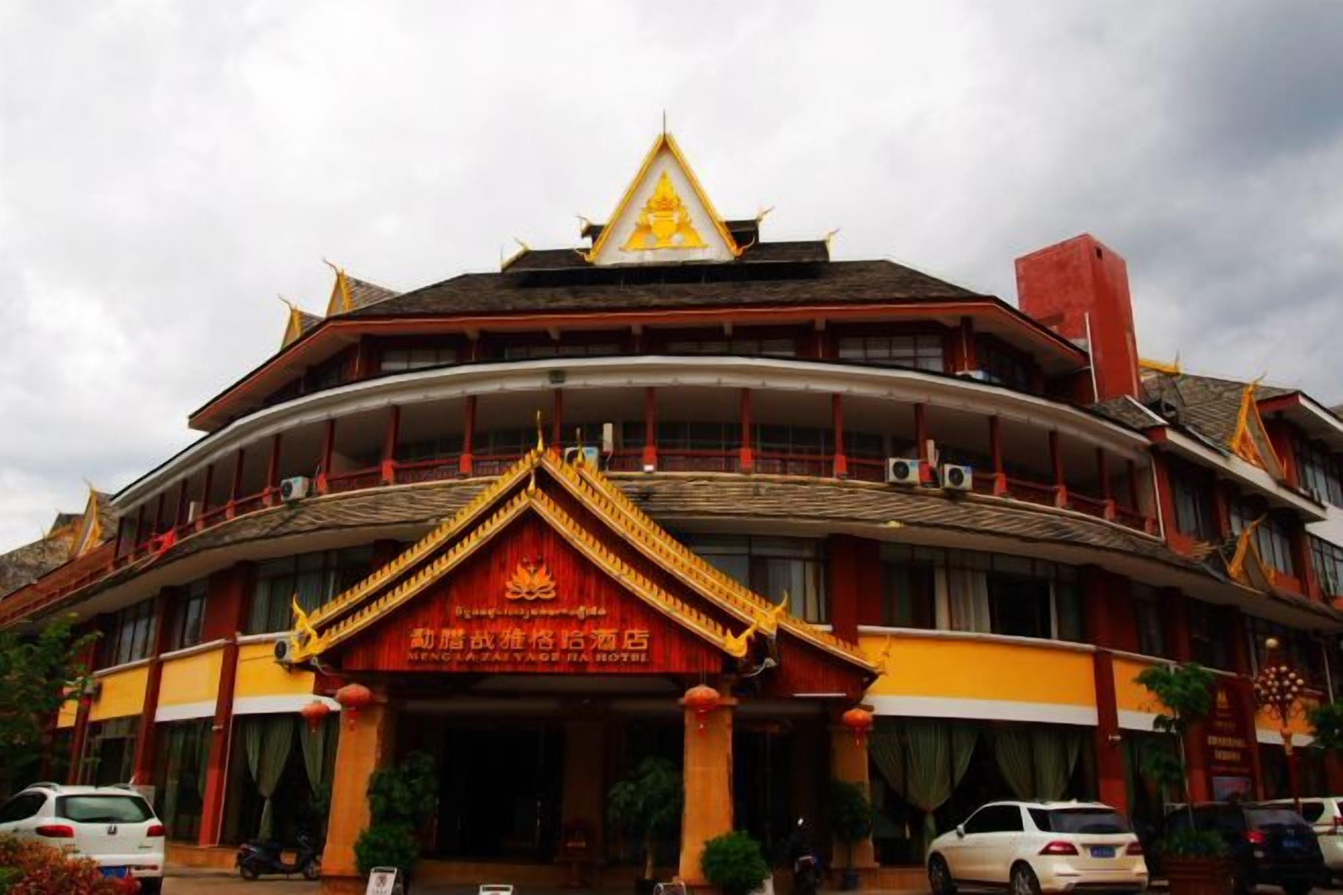 A traditional building with a curved facade, a prominent entrance with a decorative arch, and a tiered roof structure.