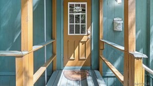 A wooden door with a window, a mailbox, and a doormat. - Rustic Lakehouse kayaks fishing bonfires (Inverness)