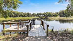 A wooden dock with two chairs and a sign prohibiting swimming. - Rustic Lakehouse kayaks fishing bonfires (Inverness)