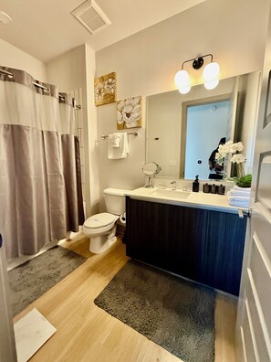 Shower, hair dryer, towels, soap - Ceiling to floor windows featuring a private balcony with stunning city views!
(Atlanta)