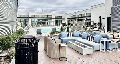 Ceiling to floor windows featuring a private balcony with stunning city views!