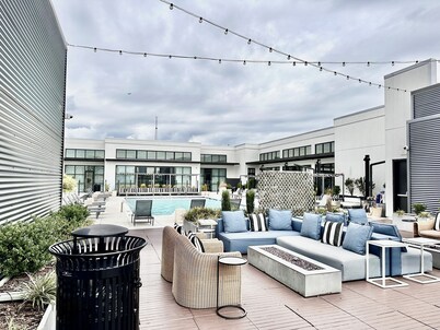 Ceiling to floor windows featuring a private balcony with stunning city views! 
