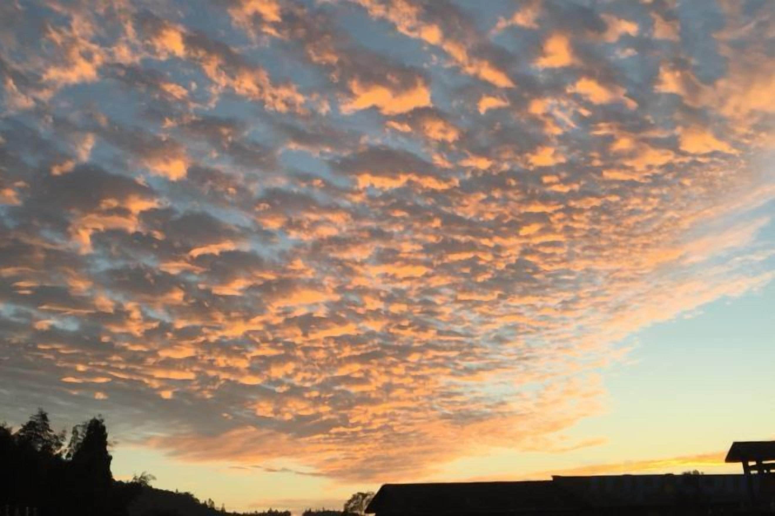A sunset with a sky filled with clouds.