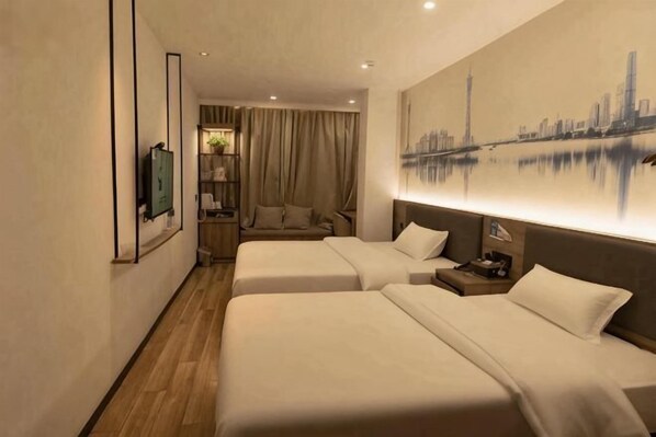 A hotel room with two beds, a sofa, a TV, and a cityscape painting.