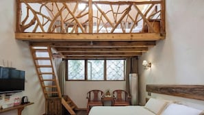 A bedroom with a loft bed, wooden ladder, two wooden chairs, a television, and a window with a view. - Moganshan Xiyuan Inn (Deqing)