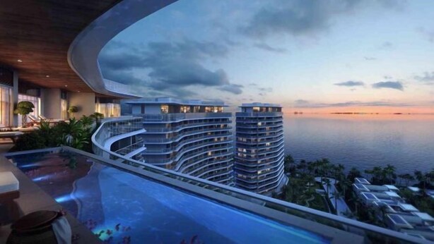 A modern hotel with a curved balcony overlooking a pool and a sunset view. - Haitang Bay Hongtai Seaview Holiday Apartment (Lingshui)