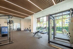 A gym with exercise equipment, large windows, and a view of the outdoors. - Jti seaview resort (Lingshui)