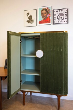 A green vintage-style wardrobe with a circular mirror and a shelf. - NEW! 5 mins to Magen's Bay and Restaurants! (St Thomas)