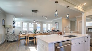 A spacious kitchen with a large island, stainless steel appliances, and pendant lighting. - Ocean-View Home- Chefs Kitchen,  Private Hot Tub, Dog Friendly, Double Patio (Pacific Beach)
