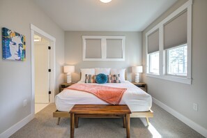 A bedroom with a bed, bedside tables, a bench, a painting, and windows. - Ocean-View Home- Chefs Kitchen,  Private Hot Tub, Dog Friendly, Double Patio (Pacific Beach)